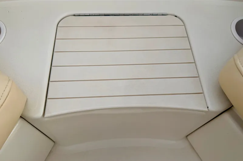 Slide: The Image of Sea Ray 210 Sundeck 2000 boat deck with beige seating and cup holders. - 53
