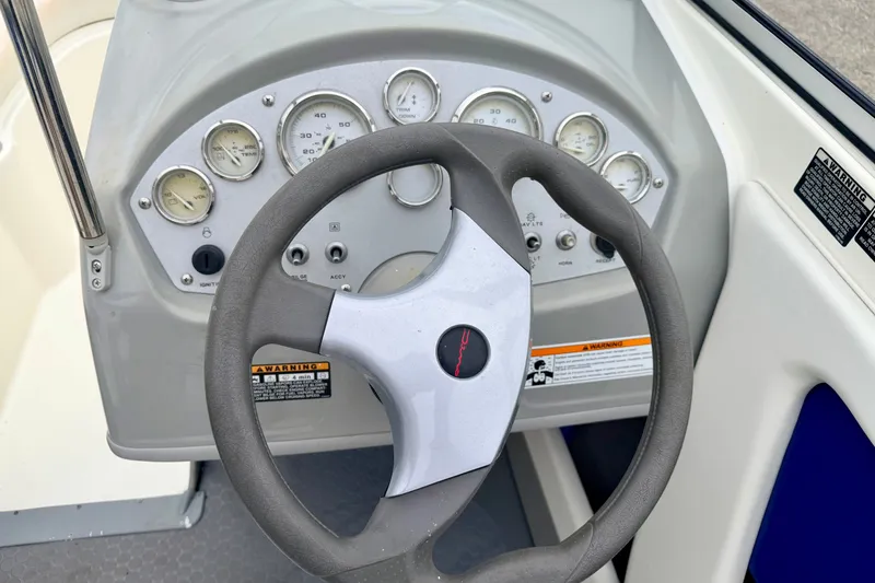 Slide: The Image of Steering wheel and dashboard of 2007 Bayliner 195 Discovery boat. - 31