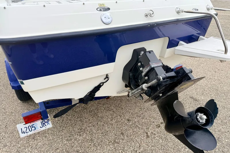 Slide: The Image of Rear view of 2007 Bayliner 195 Discovery boat with outboard motor and trailer. - 19