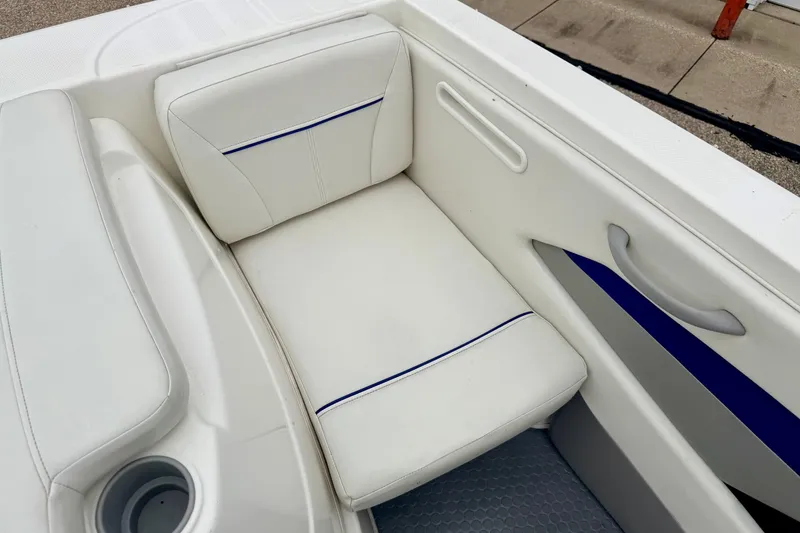 Slide: The Image of 2007 Bayliner 195 Discovery boat interior with white cushioned seating. - 24
