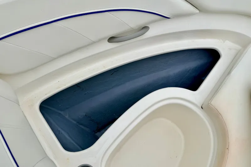 Slide: The Image of Interior detail of a 2007 Bayliner 195 Discovery boat, featuring white and blue seating. - 44