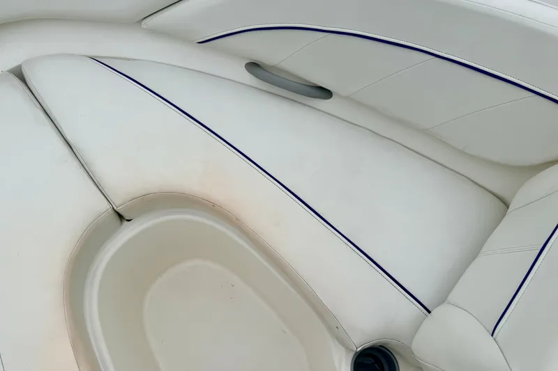 Slide: The Image of White interior seating of a 2007 Bayliner 195 Discovery boat with blue trim. - 46