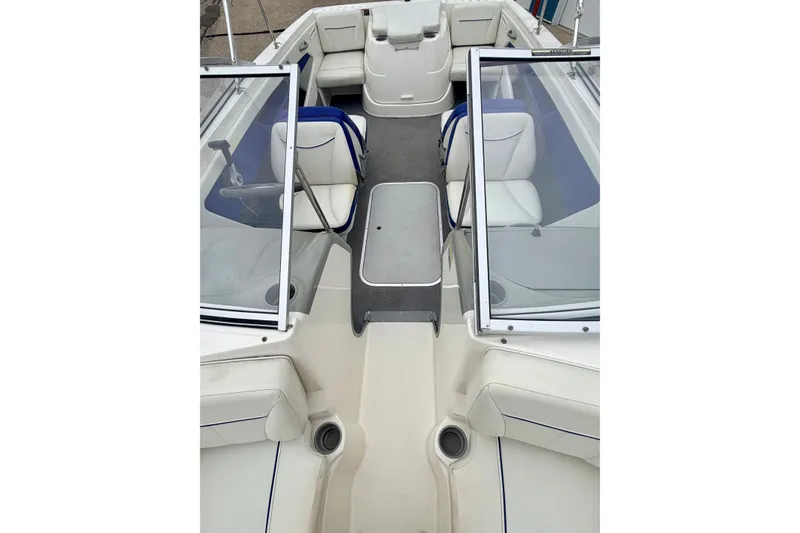 Slide: The Image of 2007 Bayliner 195 Discovery boat interior with white seating and open windshield. - 47