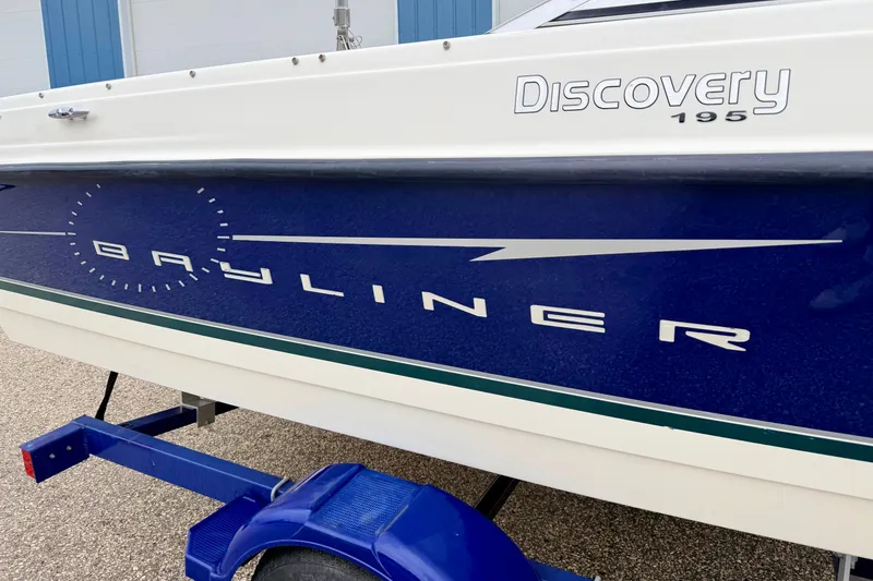 Slide: The Image of 2007 Bayliner 195 Discovery boat side view with blue and white design. - 14