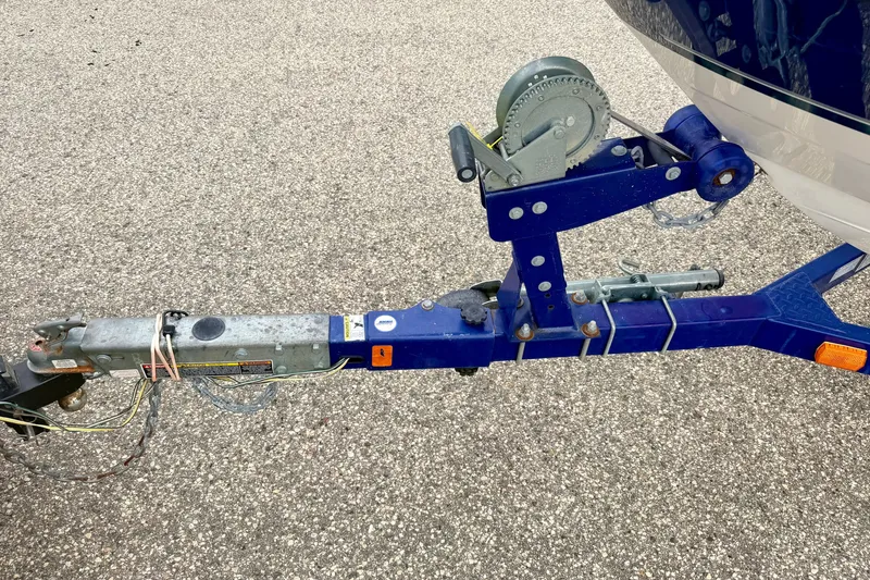 Slide: The Image of Trailer hitch of a 2007 Bayliner 195 Discovery boat on pavement. - 54