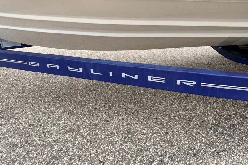 Slide: The Image of Bayliner 195 Discovery 2007 boat trailer on pavement, showcasing brand logo. - 55