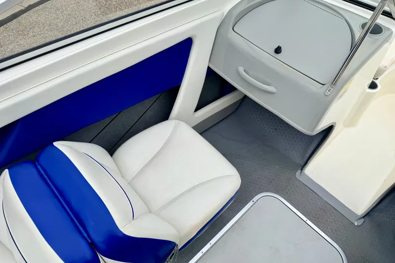 Slide: The Image of Interior of 2007 Bayliner 195 Discovery boat with blue and white seating. - 36