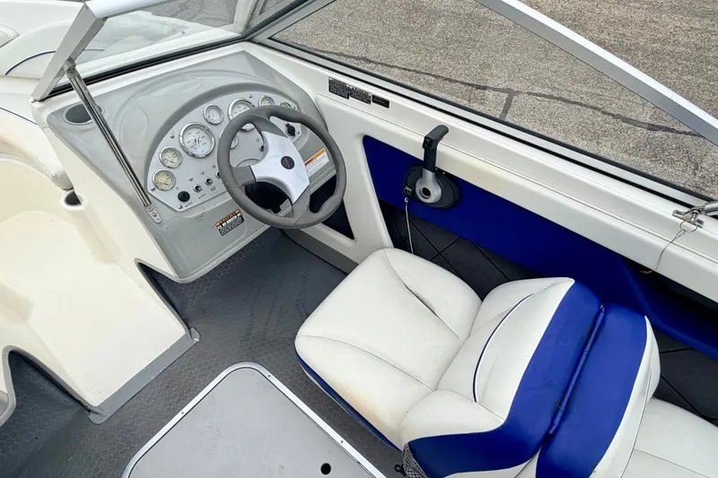 Slide: The Image of 2007 Bayliner 195 Discovery boat interior with steering wheel and gauges. - 30