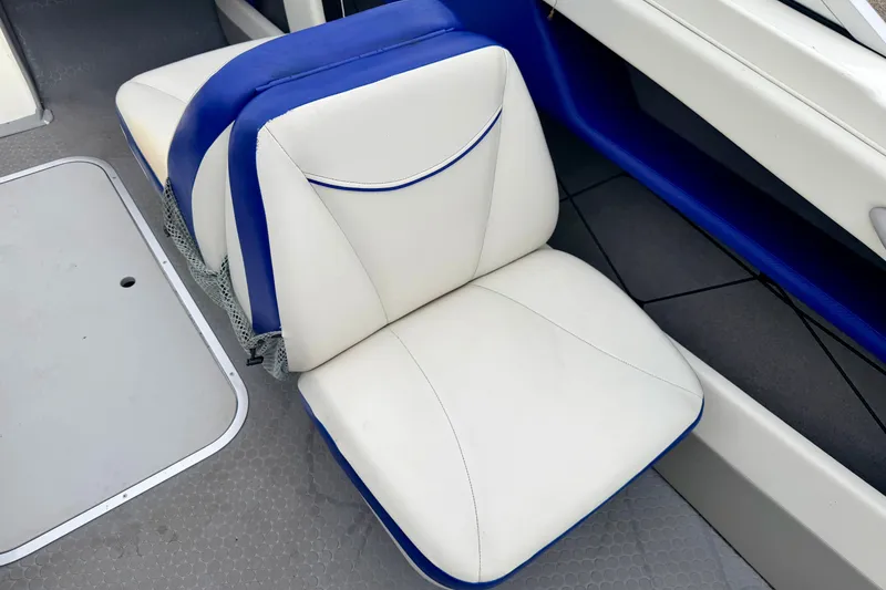Slide: The Image of White and blue seating on a 2007 Bayliner 195 Discovery boat interior. - 41
