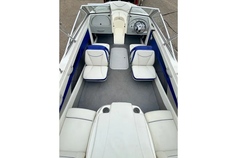 Slide: The Image of 2007 Bayliner 195 Discovery boat interior with white and blue seating. - 48