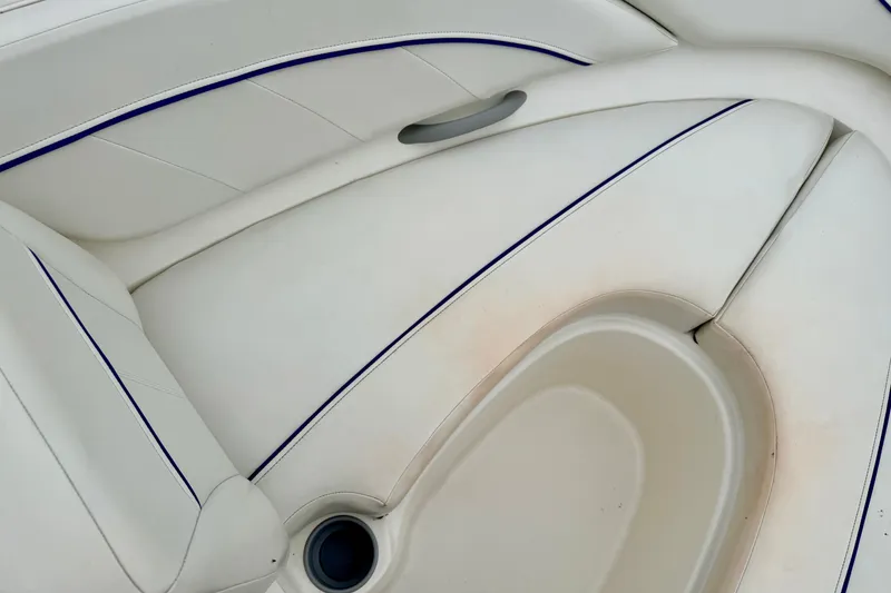 Slide: The Image of 2007 Bayliner 195 Discovery boat interior with white cushioned seating. - 43