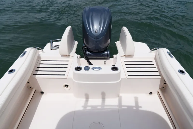 Slide: The Image of The image shows the stern of a Grady-White Adventure 218 boat with an outboard motor. - 9