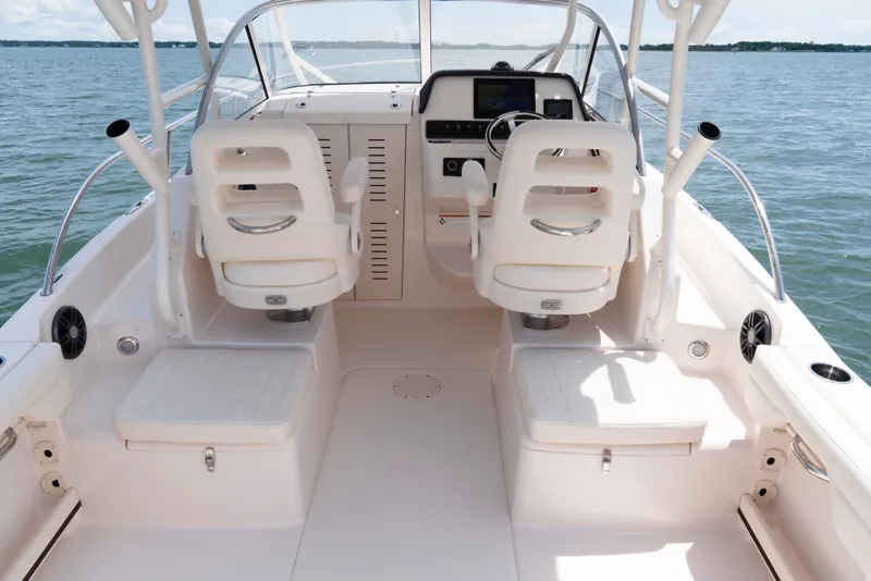 Slide: The Image of The image shows the cockpit of a 2027 Grady-White Adventure 218. It features two white seats and a modern dashboard. - 6