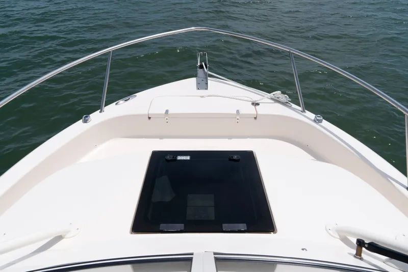 Slide: The Image of The image shows the bow deck of a Grady-White Adventure 218 boat on the water. - 4