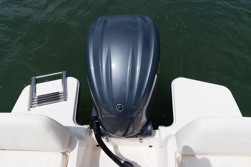 Slide: The Image of A Grady-White Adventure 218 boat with an outboard motor and swim ladder in the water. - 11
