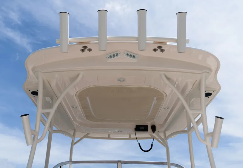 Slide: The Image of The image shows the roof of a Grady-White Adventure 218 boat with multiple fishing rod holders. - 3