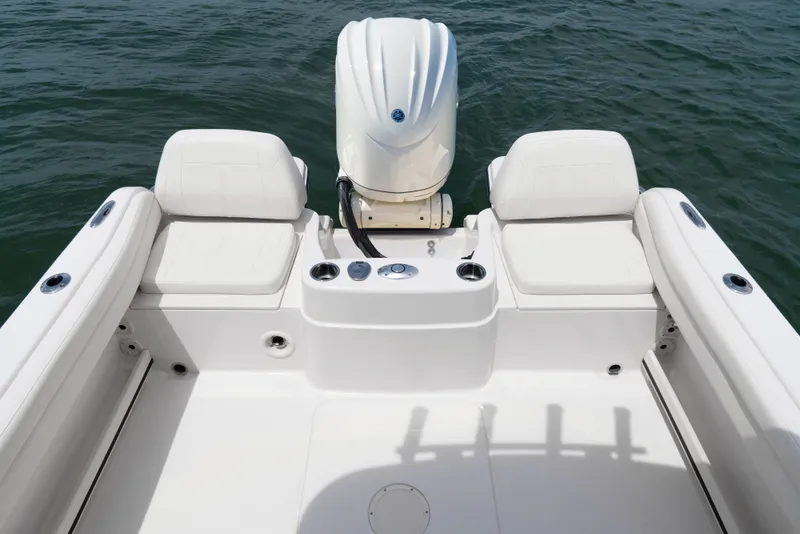 Slide: The Image of The image shows the stern of a Grady-White Adventure 218 boat with an outboard motor. - 10