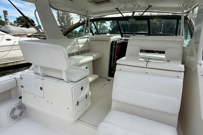 Slide: The Image of 2003 Tiara Yachts 3500 Open interior with white seating and helm station. - 10