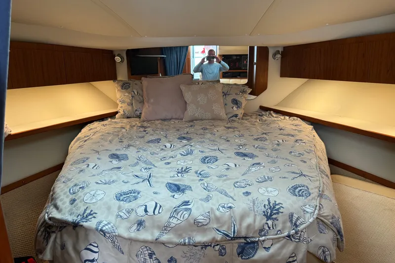 Slide: The Image of Luxurious cabin interior of 2003 Tiara Yachts 3500 Open with nautical-themed bedding. - 26