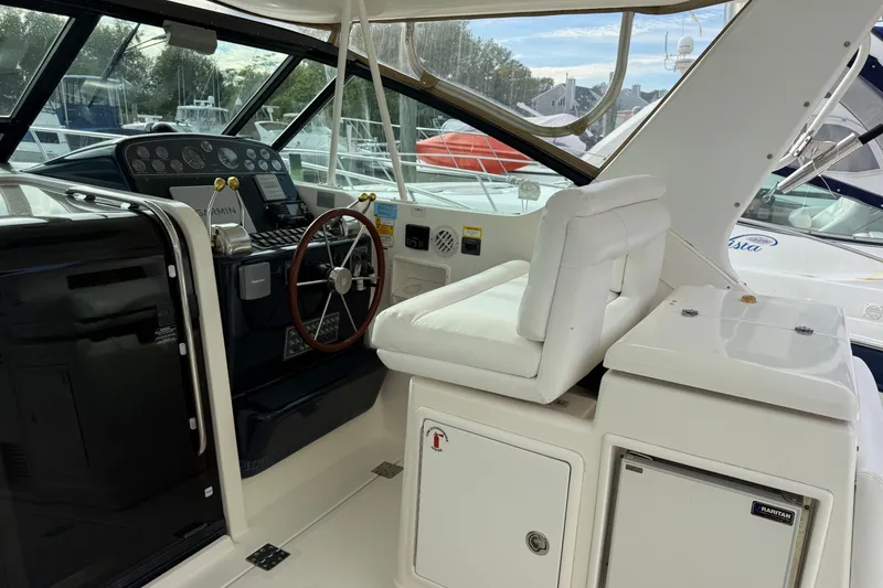 Slide: The Image of 2003 Tiara Yachts 3500 Open helm with white seating and navigation controls. - 15