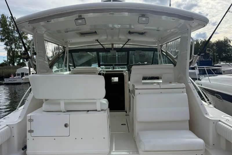 Slide: The Image of 2003 Tiara Yachts 3500 Open, spacious cockpit view with white seating and storage. - 9