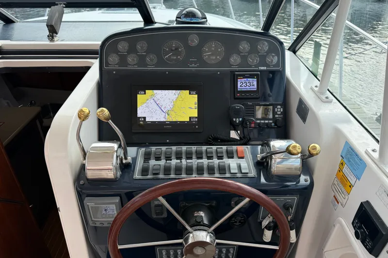 Slide: The Image of 2003 Tiara Yachts 3500 Open helm with navigation equipment and controls. - 13