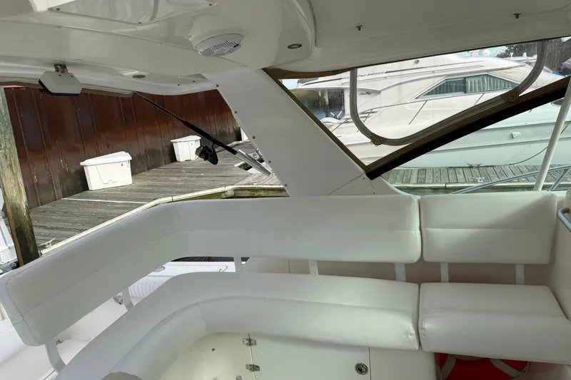 Slide: The Image of 2003 Tiara Yachts 3500 Open interior with white seating and dock view. - 16