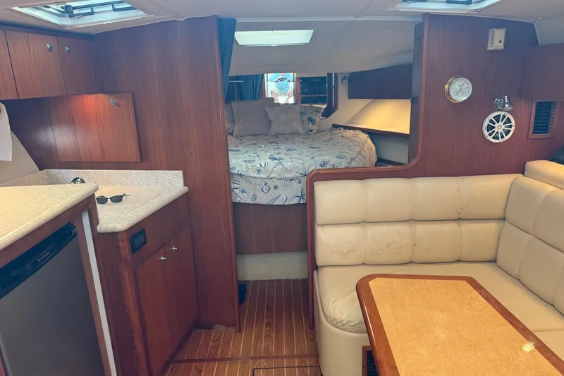 Slide: The Image of Interior of 2003 Tiara Yachts 3500 Open with cozy seating and sleeping area. - 20