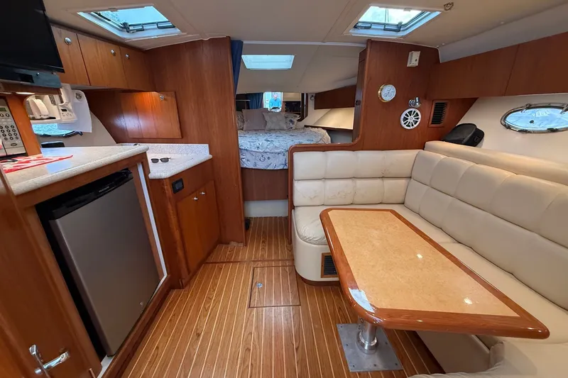 Slide: The Image of Interior of 2003 Tiara Yachts 3500 Open, featuring cozy seating and modern amenities. - 22