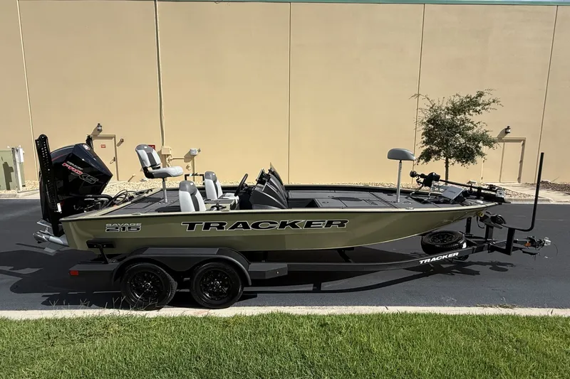 The Image of 2027 Tracker Savage 215 boat on trailer, parked outdoors, side view. - 0