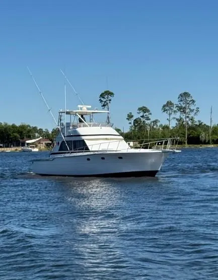 Slide: The Image of 1989 Ricker 48 Convertible yacht cruising on a sunny day. - 1
