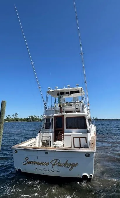 Slide: The Image of 1989 Ricker 48 Convertible yacht on water, rear view, clear sky. - 29