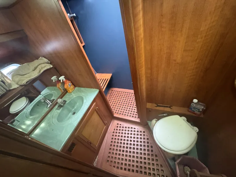 Slide: The Image of 1989 Ricker 48 Convertible yacht bathroom with dual sinks and wooden accents. - 16