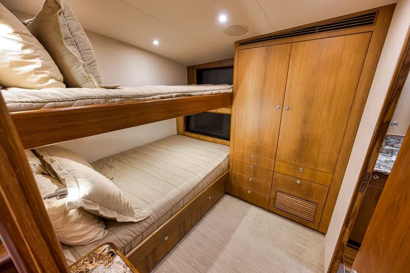 Slide: The Image of Cozy cabin interior of 1995 Merritt 65 Sport Fish with wooden bunk beds and storage. - 53