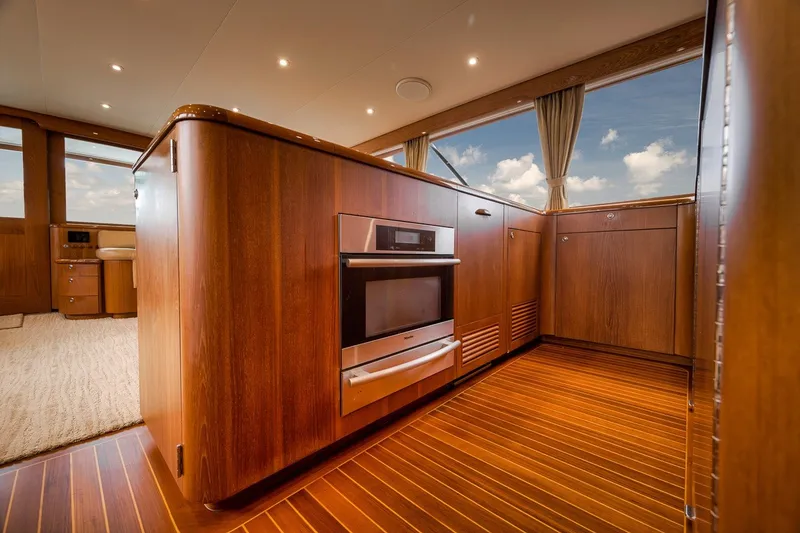 Slide: The Image of Luxurious interior of 1995 Merritt 65 Sport Fish yacht with wood paneling and modern appliances. - 40