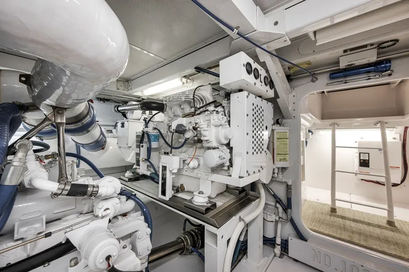 Slide: The Image of Engine room of a 1995 Merritt 65 Sport Fish boat, showcasing machinery and equipment. - 27