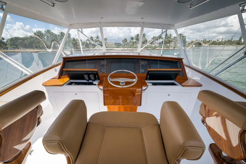 Slide: The Image of Helm of 1995 Merritt 65 Sport Fish yacht with leather seating and wooden accents. - 6