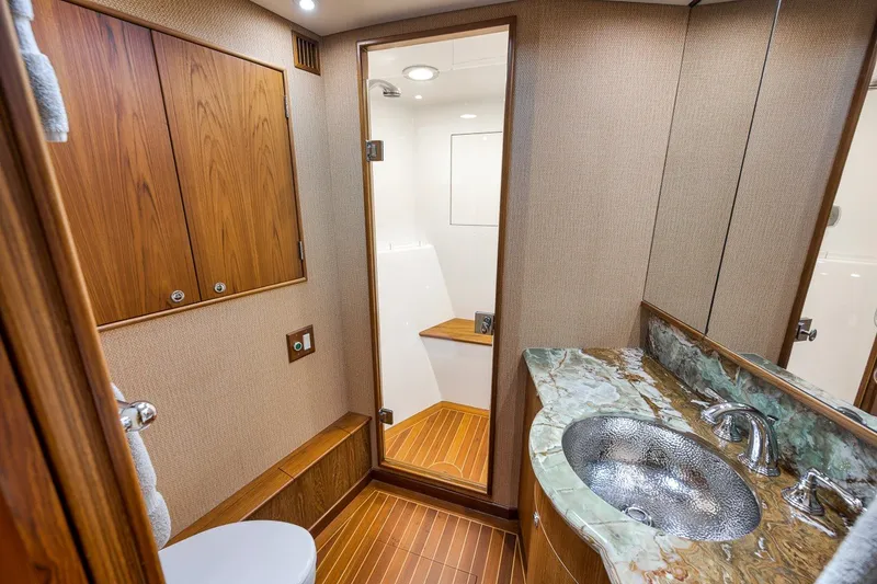Slide: The Image of Luxurious bathroom interior of 1995 Merritt 65 Sport Fish yacht with marble sink and wooden cabinetry. - 50