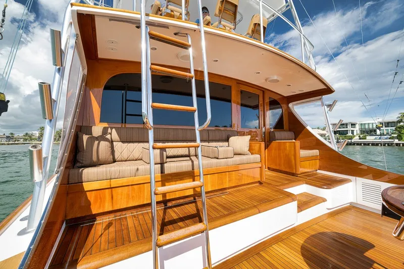 Slide: The Image of Luxurious 1995 Merritt 65 Sport Fish yacht with polished wood deck and comfortable seating. - 16