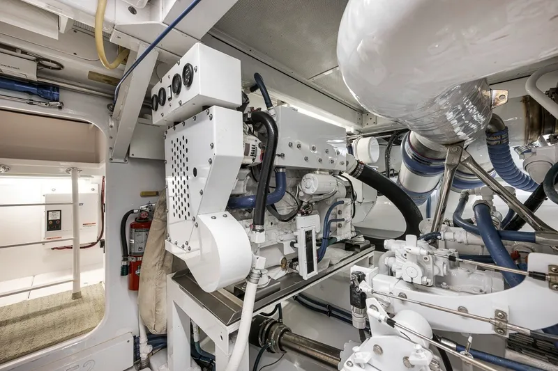Slide: The Image of Engine room of a 1995 Merritt 65 Sport Fish boat, showcasing machinery and equipment. - 28