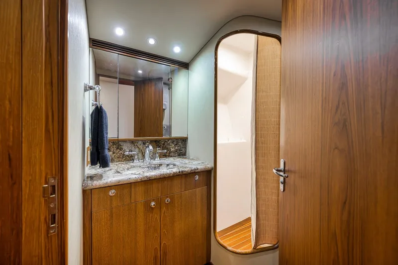 Slide: The Image of Luxurious bathroom interior of 1995 Merritt 65 Sport Fish yacht with wood accents. - 52