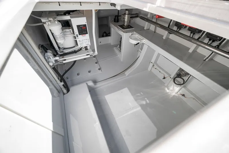 Slide: The Image of Engine room of 1995 Merritt 65 Sport Fish boat, showcasing mechanical components and clean layout. - 34