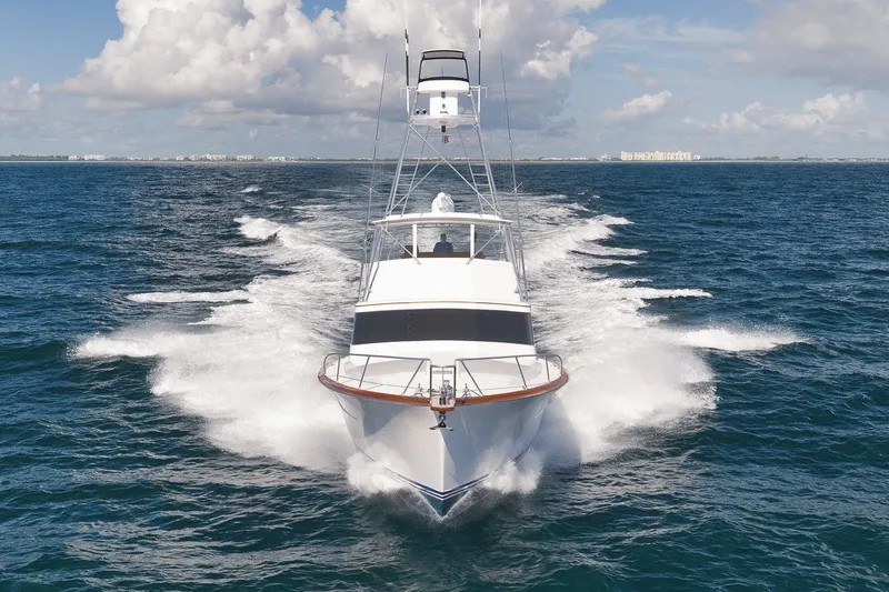 Slide: The Image of 1995 Merritt 65 Sport Fish yacht cruising on open ocean under clear skies. - 4