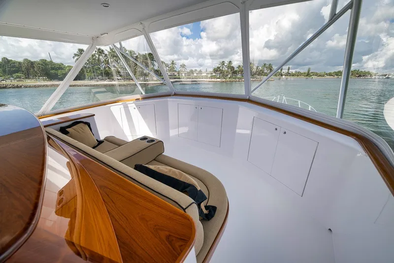 Slide: The Image of Luxurious 1995 Merritt 65 Sport Fish yacht interior with plush seating and scenic ocean view. - 10