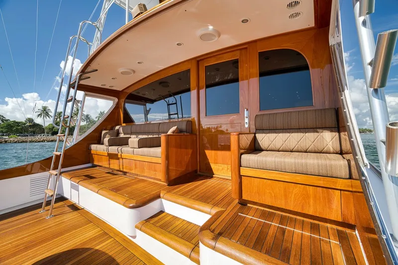 Slide: The Image of Luxurious 1995 Merritt 65 Sport Fish yacht with elegant wooden deck and seating. - 15