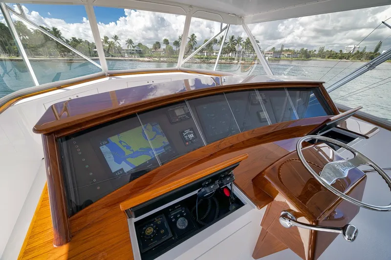 Slide: The Image of Cockpit view of 1995 Merritt 65 Sport Fish yacht with navigation display and steering wheel. - 7