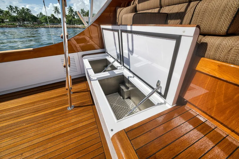 Slide: The Image of Open storage compartments on 1995 Merritt 65 Sport Fish boat deck with wooden finish. - 19