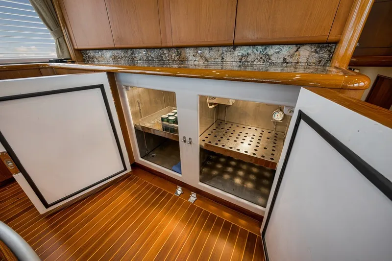 Slide: The Image of Open cabinet on Merritt 65 Sport Fish yacht, showcasing storage space, 1995 model. - 39