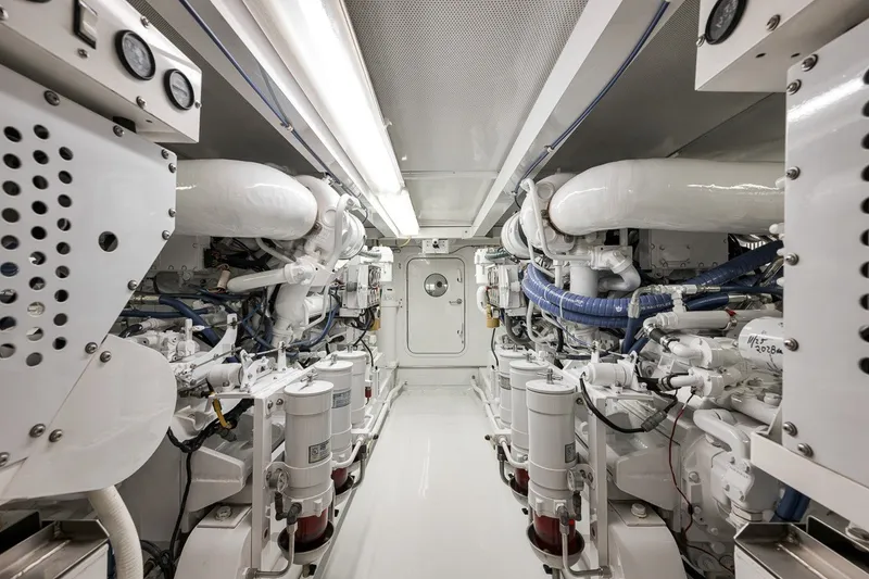 Slide: The Image of Engine room of a 1995 Merritt 65 Sport Fish yacht, showcasing machinery and components. - 29