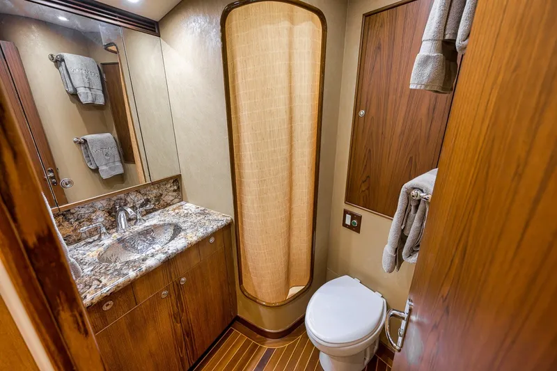 Slide: The Image of Luxurious bathroom on 1995 Merritt 65 Sport Fish yacht with marble sink and wooden accents. - 54